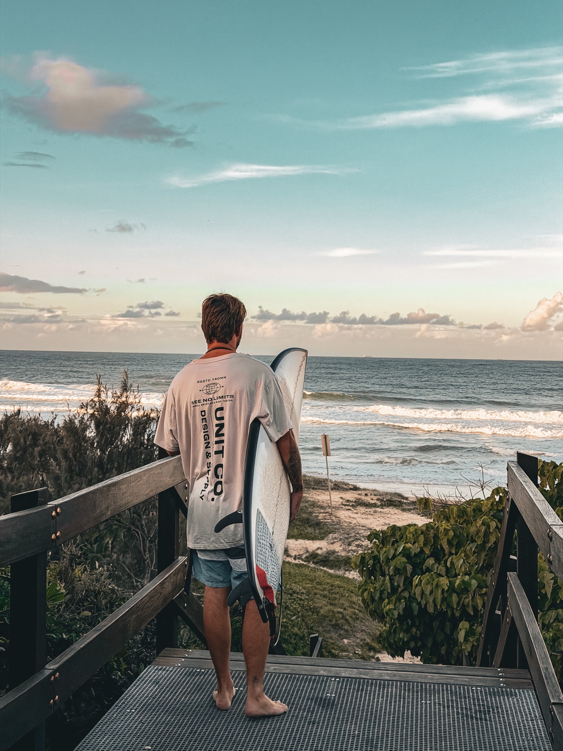 Surfer walking toward the ocean
